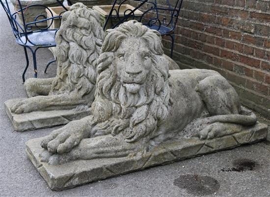 A pair of reconstituted stone garden statues modelled as seated lions, 4ft